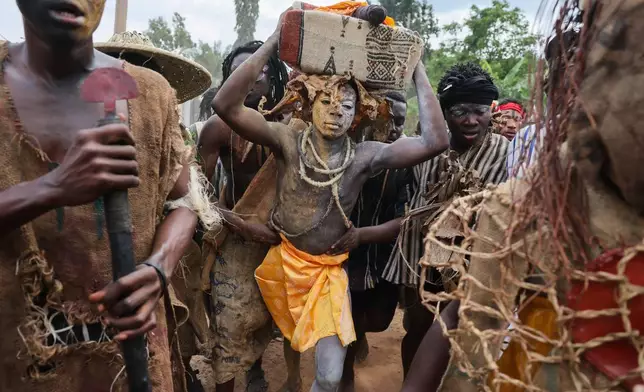 A young man plays the role of a prisoner during the re-enactment of the Akatamanso War as part of the Odwira Festival celebrations in Larteh, Ghana, Wednesday, Sept. 30, 2026. (AP Photo)