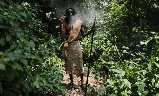 A man smokes a pipe in a re-enactment of the Akatamanso War during the Odwira Festival celebrations in Larteh, Ghana, Wednesday, Sept. 30, 2026. (AP Photo)