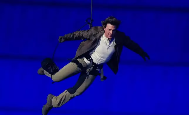 FILE - Tom Cruise is lowered on the Stade de France during the 2024 Summer Olympics closing ceremony, Aug. 11, 2024, in Saint-Denis, France. (AP Photo/Natacha Pisarenko, File)