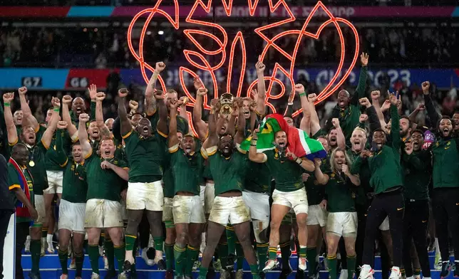 FILE - South Africa's Siya Kolisi holds the trophy aloft during the presentation ceremony after the Rugby World Cup final match between New Zealand and South Africa at the Stade de France in Saint-Denis, near Paris, France, Oct. 28, 2023. (AP Photo/Thibault Camus, File)