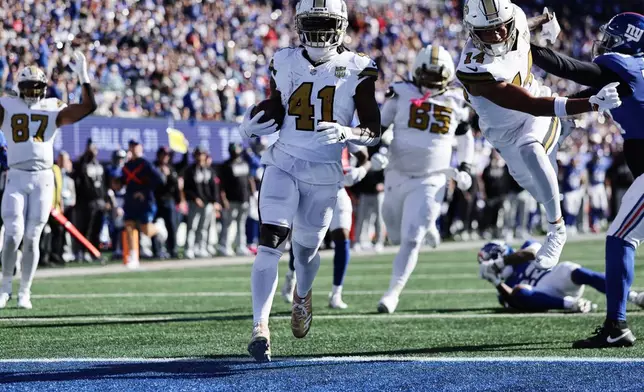 New Orleans Saints running back Alvin Kamara (41) runs into the end zone for a touchdown during the second half of an NFL football game against the New York Giants in East Rutherford, N.J., Sunday, Oct. 18, 2026. (AP Photo/Adam Hunger)