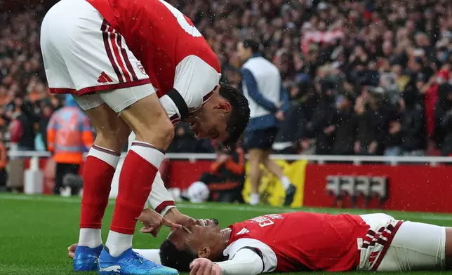 Arsenal's Kai Havertz, top, and Gabriel celebrate second goal scoring second goal during the English Premier League soccer match between Arsenal and Everton in London, Saturday, Oct. 24, 2026. (AP Photo/Ian Walton)