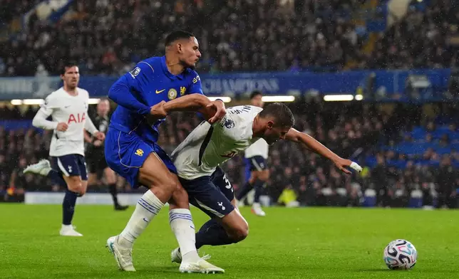 Chelsea's Maxence Lacroix, left, and Tottenham Hotspur's Micky van de Ven battle for the ball during the English Premier League soccer match between Chelsea and Tottenham Hotspur in London, Saturday, Oct. 24, 2026. (John Walton/PA via AP)