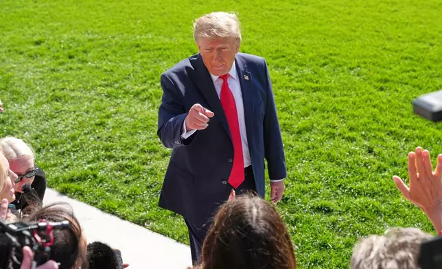 President Donald Trump speaks with reporters before departing on Marine One from the South Lawn of the White House, Friday, Oct. 23, 2026, in Washington. (AP Photo/Alex Brandon)