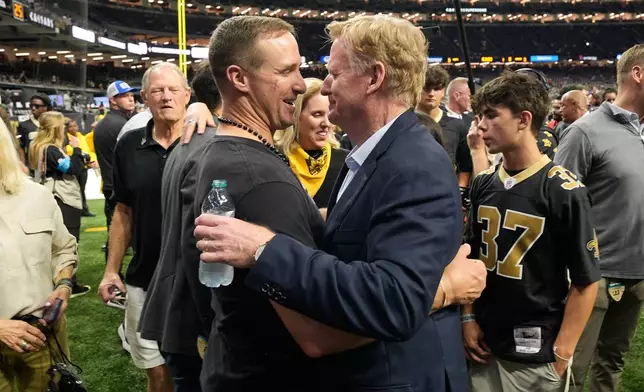 Former New Orleans Saints quarterback Drew Brees, middle left, greets NFL Commissioner Roger Goodell before an NFL football game between the Saints and the Atlanta Falcons in New Orleans, Monday, Oct. 5, 2026. (AP Photo/Gerald Herbert)