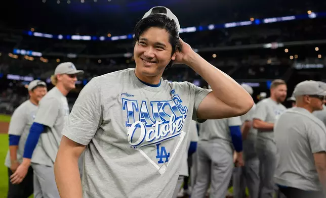 Los Angeles Dodgers two-way player Shohei Ohtani celebrates winning Game 4 of baseball's National League Division Series against the Atlanta Braves, Wednesday, Oct. 7, 2026, in Atlanta. (AP Photo/Mike Stewart)