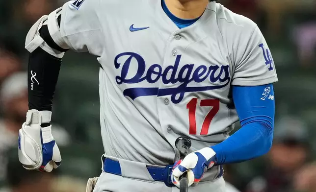 Los Angeles Dodgers' Shohei Ohtani reaches for his waist after taking a swing during an at-bat in the eighth inning in Game 3 of baseball's National League Division Series against the Atlanta Braves, Tuesday, Oct. 6, 2026, in Atlanta. (AP Photo/Brynn Anderson)
