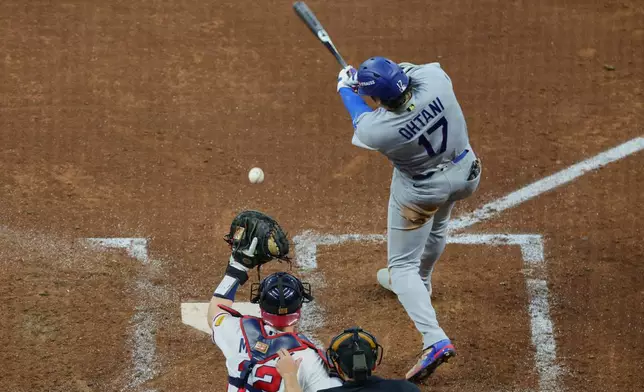 Los Angeles Dodgers two-way player Shohei Ohtani (17) strikes out as Atlanta Braves catcher Sean Murphy (12) makes the catch during the fourth inning in Game 4 of baseball's National League Division Series, Wednesday, Oct. 7, 2026, in Atlanta. (AP Photo/Colin Hubbard)