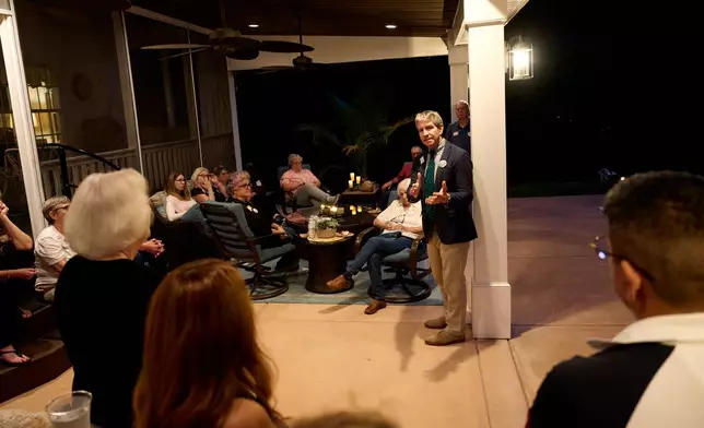 Paul Barringer, the Democratic nominee running for North Carolina's 13th Congressional District, speaks with voters at a campaign event, Oct. 8, 2026, in Garner, N.C. (AP Photo/Matt Ramey)