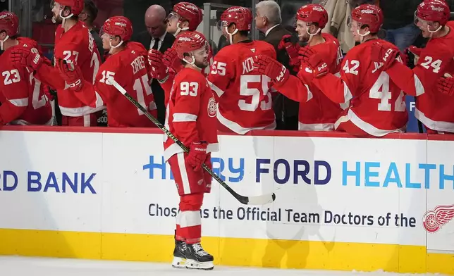 Detroit Red Wings right wing Alex DeBrincat (93) celebrates his goal against the New Jersey Devils in the third period of an NHL hockey game Tuesday, Oct. 13, 2026, in Detroit. (AP Photo/Paul Sancya)
