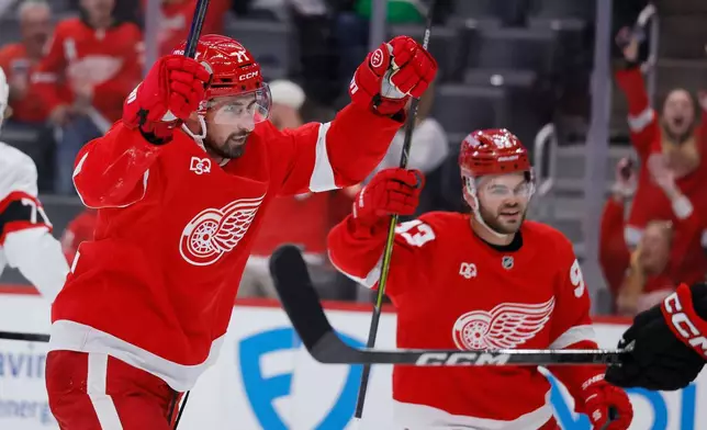 Detroit Red Wings center Dylan Larkin (71) and right wing Alex DeBrincat (93) celebrate a goal by left wing Viktor Arvidsson (33) against the Ottawa Senators during the second period of an NHL hockey game Tuesday, Oct. 6, 2026, in Detroit. (AP Photo/Duane Burleson)