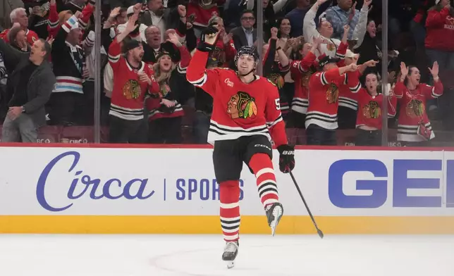 Chicago Blackhawks defenseman Artyom Levshunov (55) celebrates a goal by center Anton Frondell against the St. Louis Blues during the second period of an NHL hockey game, Tuesday, Oct. 6, 2026, in Chicago. (AP Photo/David Banks)
