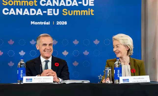 President of the European Commission Ursula von der Leyen, right, gives remarks alongside Prime Minister Mark Carney at a roundtable with business leaders during the Canada-EU Summit in Montreal, Thursday, Oct. 29, 2026. (Christopher Katsarov/The Canadian Press via AP)