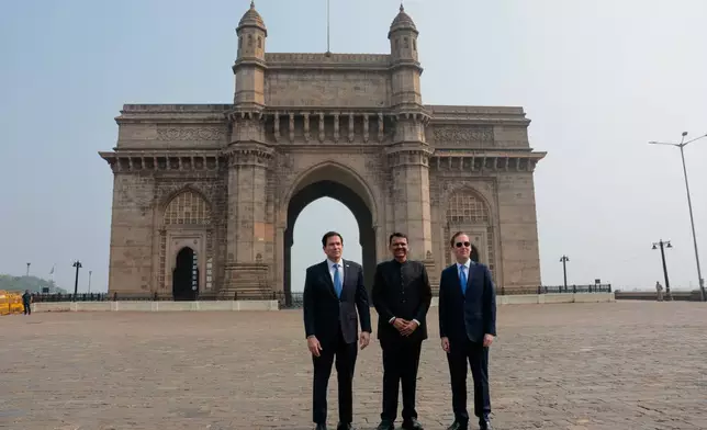 US Secretary of State Marco Rubio, left, Maharashtra Chief Minister Devendra Fadnavis, second left, and US ambassador to India Sergio Gor, right, pose for a photo at the Gateway of India in Mumbai, India, Tuesday, Oct. 20, 2026. (Kylie Cooper/Pool Photo via AP)