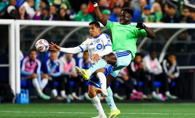 Seattle Sounders defender Yéimar Gómez Andrade, right, battles with CF Montréal forward Alexis Sánchez, left, for a loose ball during the first half of an MLS soccer match, Saturday, Oct. 17, 2026, in Seattle. (AP Photo/Rio Giancarlo)