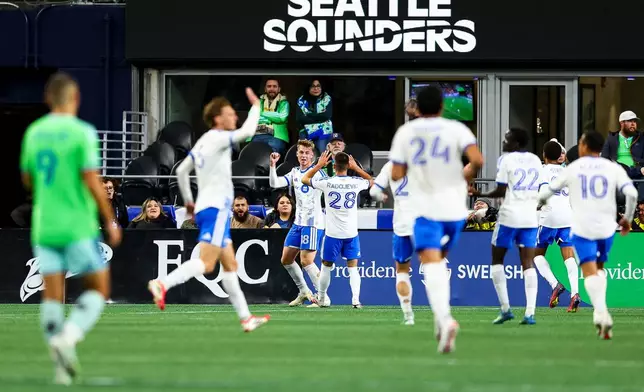 CF Montréal midfielder Hennadii Synchuk (18), center, celebrates with defender Viktor Radojević (28) after scoring during the first half of an MLS soccer match against the Seattle Sounders, Saturday, Oct. 17, 2026, in Seattle. (AP Photo/Rio Giancarlo)