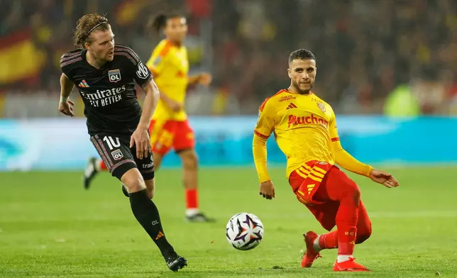 Lyon's Pavel Sulc, left, in action during the French League One soccer match between Lens and Lyon, in Lens, France, Friday, Oct. 9, 2026. (AP Photo/Jean-Francois Badias)