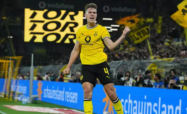 Dortmund's Nico Schlotterbeck celebrates after scoring during the German Bundesliga soccer match between Borussia Dortmund and Werder Bremen in Dortmund, Germany, Friday, Oct. 9, 2026. (AP Photo/Martin Meissner)
