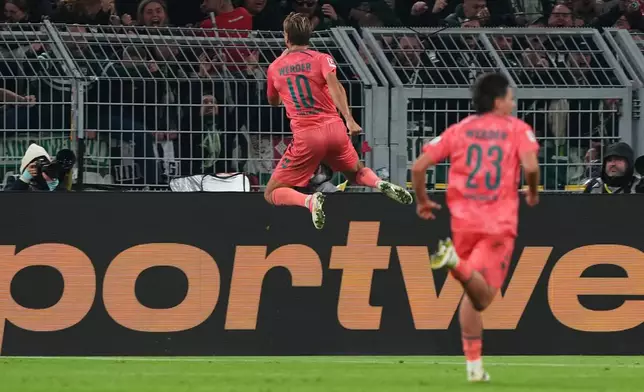Bremen's Niclas Fuellkrug, center, celebrates after scoring during the German Bundesliga soccer match between Borussia Dortmund and Werder Bremen in Dortmund, Germany, Friday, Oct. 9, 2026. (AP Photo/Martin Meissner)