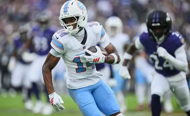 Tennessee Titans wide receiver Carnell Tate (14) runs after a catch during the first half of an NFL football game against the Baltimore Ravens in Baltimore, Sunday, Oct. 4, 2026. (AP Photo/Nick Wass)