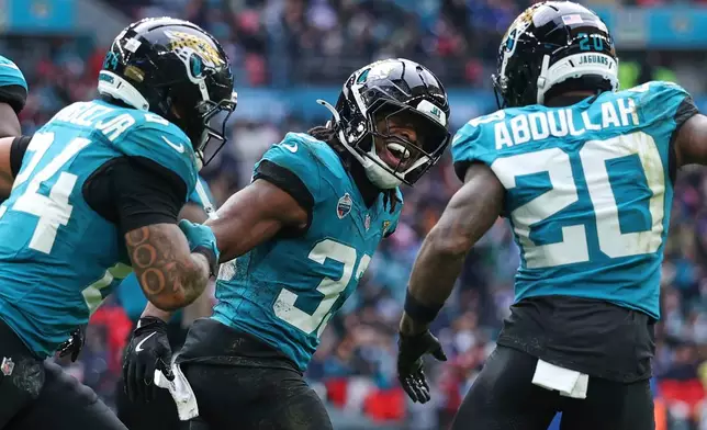 Jacksonville Jaguars running back Bhayshul Tuten (33) celebrates after scoring his side's second touchdown during an NFL football game against Houston Texans in London, Sunday, Oct. 18, 2026. (AP Photo/Ian Walton)