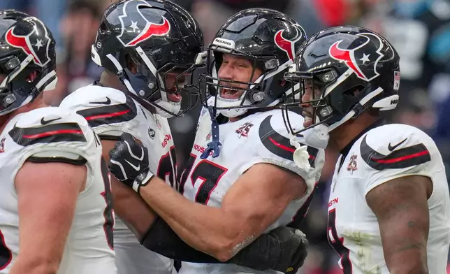 Houston Texans tight end Foster Moreau (87), second right, celebrates after scoring his side's second touchdown during an NFL football game against Jacksonville Jaguars in London, Sunday, Oct. 18, 2026. (AP Photo/Kin Cheung)