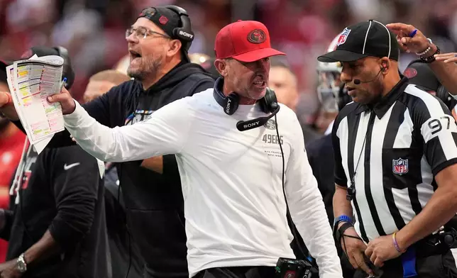San Francisco 49ers head coach Kyle Shanahan, left, talks to line judge Brian Perry (97) during the second half of an NFL football game against the Atlanta Falcons in Atlanta, Sunday, Oct. 25, 2026. (AP Photo/Mike Stewart)