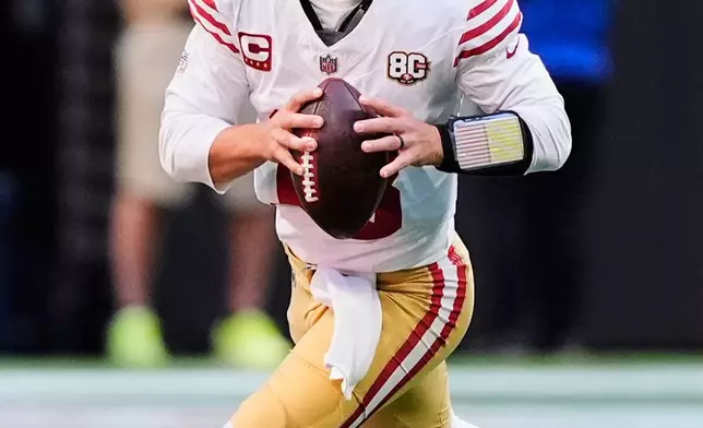 San Francisco 49ers quarterback Brock Purdy scrambles before throwing a pass during the first half of an NFL football game against the Atlanta Falcons in Atlanta, Sunday, Oct. 25, 2026. (AP Photo/Brynn Anderson)