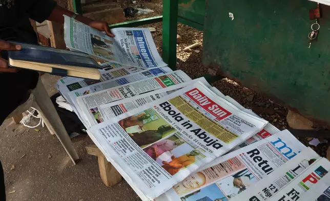 A man sells newspapers in Abuja, Nigeria Wednesday, Oct. 21, 2026. (AP Photo/Afolabi Sotunde)