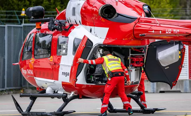 A patient who is suspected to have Ebola is transferred in a isolation unit from a rescue aircraft to a rescue helicopter of Swiss Air Rescue (Rega) at Zurich Airport on Monday, Oct. 26, 2026, in Zurich, Switzerland.(Michael Buholzer/Keystone via AP)