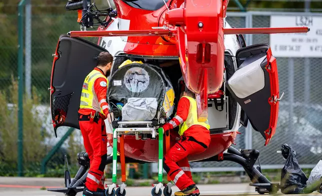 A patient who is suspected to have Ebola is transferred in a isolation unit from a rescue aircraft to a rescue helicopter of Swiss Air Rescue (Rega) at Zurich Airport on Monday, Oct. 26, 2026, in Zurich, Switzerland.(Michael Buholzer/Keystone via AP)