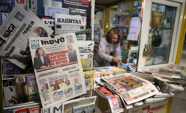 Front pages of Bulgarian newspapers display the results of the first round of the presidential election in Sofia, Bulgaria, Monday, Oct. 26, 2026, as incumbent leftist Iliana Yotova and pro-Western reformist Andrey Gyurov advance to a Nov. 1 runoff following record-low voter turnout amid widespread political distrust. (AP Photo/Valentina Petrova)