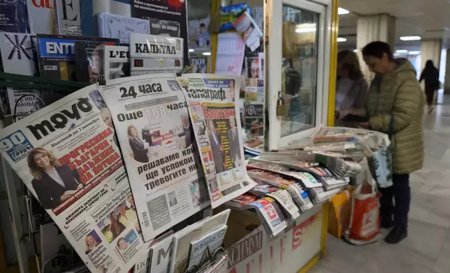 Front pages of Bulgarian newspapers display the results of the first round of the presidential election in Sofia, Bulgaria, Monday, Oct. 26, 2026, as incumbent leftist Iliana Yotova and pro-Western reformist Andrey Gyurov advance to a Nov. 1 runoff following record-low voter turnout amid widespread political distrust. (AP Photo/Valentina Petrova)