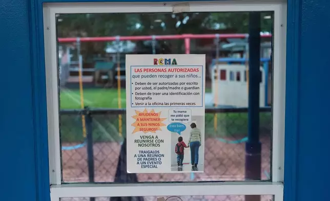 A sign in Spanish advises parents of safety procedures around school pick-up and encourages them to meet with teachers, at a Head Start preschool in Immokalee, Fla., Thursday, Sept. 10, 2026. (AP Photo/Rebecca Blackwell)