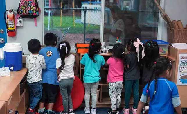 Children look out their classroom window during a thunder storm at a Head Start preschool in Immokalee, Fla., Thursday, Sept. 10, 2026. (AP Photo/Rebecca Blackwell)
