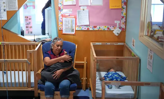 A teacher comforts a young child at a Head Start preschool in Immokalee, Fla., Thursday, Sept. 10, 2026. (AP Photo/Rebecca Blackwell)