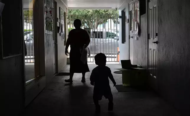 A parent walks with her child at a Head Start preschool in Immokalee, Fla., Thursday, Sept. 10, 2026. (AP Photo/Rebecca Blackwell)