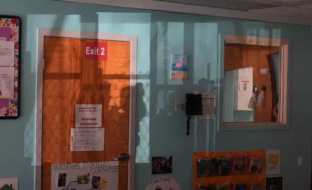 The shadow of a parent picking up her child is cast on a classroom wall at a Head Start preschool in Immokalee, Fla., Thursday, Sept. 10, 2026. (AP Photo/Rebecca Blackwell)