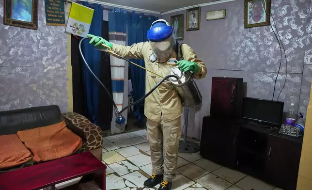 A worker prepares to spray insecticide inside a room to help prevent the spread of malaria in Malabo, Equatorial Guinea, April 24, 2026. (AP Photo/Misper Apawu)
