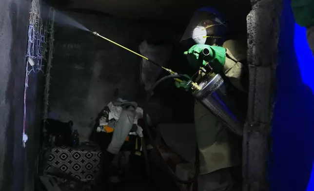A worker sprays insecticide to help prevent the spread of malaria in Malabo, Equatorial Guinea, April 24, 2026, (AP Photo/Misper Apawu)