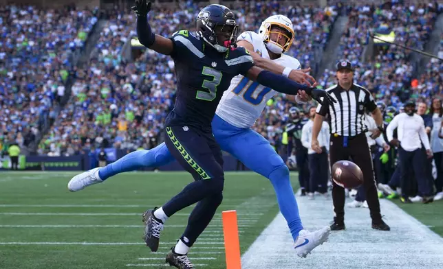 Seattle Seahawks safety Nick Emmanwori (3) breaks up a pass intended for Los Angeles Chargers quarterback Justin Herbert (10) during the second half of an NFL football game, Sunday, Oct. 4, 2026, in Seattle. (AP Photo/Lindsey Wasson)
