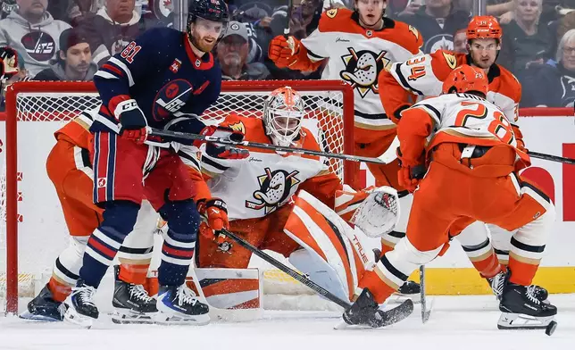 Anaheim Ducks goaltender Lukas Dostal, center, watches a rebound during the first period of an NHL hockey game against the Winnipeg Jets in Winnipeg, Manitoba, Friday, Oct. 9, 2026. (John Woods/The Canadian Press via AP)