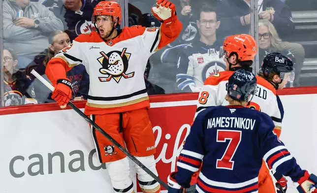 Anaheim Ducks' Tim Washe, left, celebrates after his goal against the Winnipeg Jets during the second period of an NHL hockey game in Winnipeg, Manitoba, Friday, Oct. 9, 2026. (John Woods/The Canadian Press via AP)