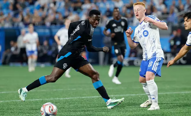 Charlotte FC forward Rodolfo Aloko, left, and CF Montreal midfielder Matty Longstaff (8) battle for the ball during the first half of an MLS soccer match in Charlotte, N.C., Wednesday, Oct. 28, 2026. (AP Photo/Nell Redmond)