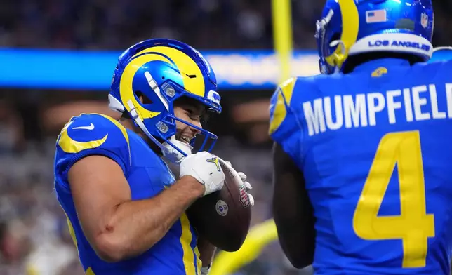 Los Angeles Rams wide receiver Puka Nacua, left, celebrates his touchdown catch with wide receiver Konata Mumpfield during the second half of an NFL football game against the Buffalo Bills, Monday, Oct. 12, 2026, in Inglewood, Calif. (AP Photo/Scott Strazzante)