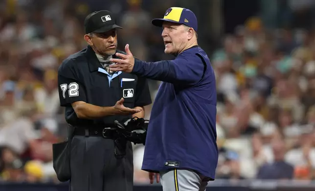 Milwaukee Brewers manager Pat Murphy, right, talks with home plate umpire Alfonso Márquez (72) during the seventh inning in Game 3 of baseball's National League Division Series against the San Diego Padres Tuesday, Oct. 6, 2026, in San Diego. (AP Photo/Derrick Tuskan)