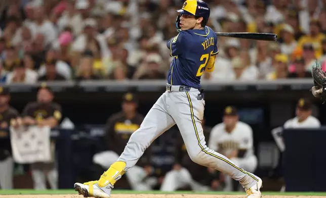 Milwaukee Brewers' Christian Yelich follows through on a RBI single during the seventh inning in Game 3 of baseball's National League Division Series against the San Diego Padres Tuesday, Oct. 6, 2026, in San Diego. (AP Photo/Derrick Tuskan)