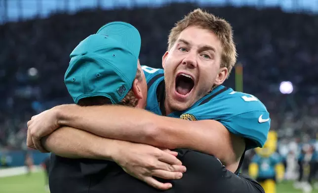 Jacksonville Jaguars place kicker Cam Little (39) celebrates after scoring the winning field goal during an NFL football game against Philadelphia Eagles in London, Sunday, Oct. 11, 2026. (AP Photo/Ian Walton)