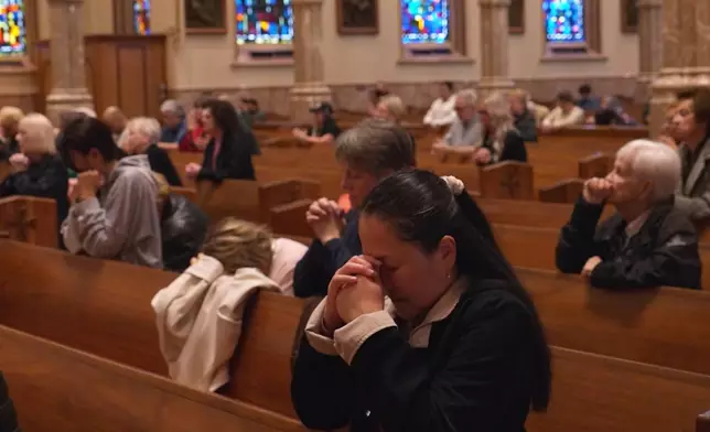 In this screengrab made from video, people pray at a votive mass for Pope Leo XIV in light of his lung cancer diagnosis at Holy Name Cathedral in Chicago, Wednesday, Oct. 14, 2026. (AP Photo/Laura Bargfeld)