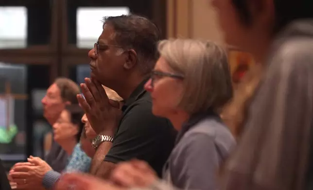 In this screengrab made from video, people pray at a votive mass for Pope Leo XIV in light of his lung cancer diagnosis at Holy Name Cathedral in Chicago, Wednesday, Oct. 14, 2026. (AP Photo/Laura Bargfeld)